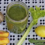 Green smoothie with ingredients around the smoothie
