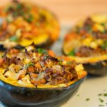 Three Acorn squash halves stuffed with herbed turkey