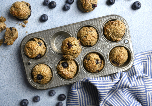muffin tin with blueberry hemp muffins