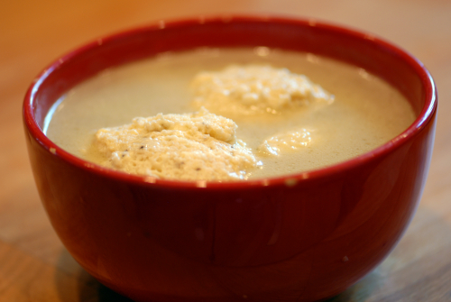 Matzo Ball Soup in a red bowl