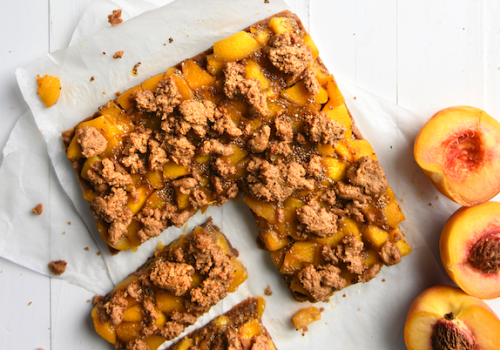 Peach bars laying on parchment paper