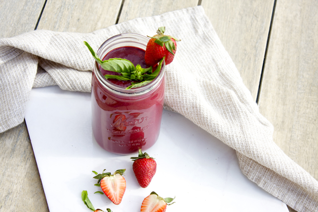 Strawberry Basil Smoothie with a napkin and cut strawberries