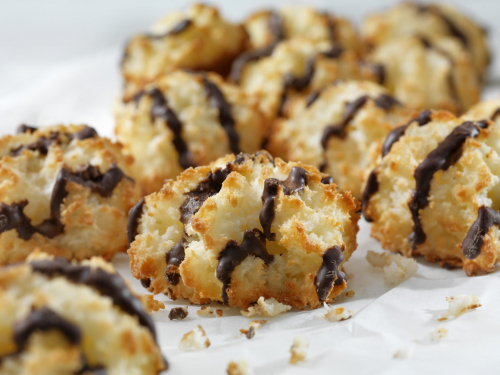 Vanilla Almond Macaroons with Chocolate Drizzle in a row on parchment paper
