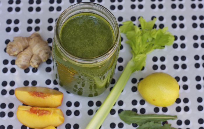 Green smoothie with ingredients around the smoothie